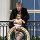 Illustration for article titled Crowd Shocked After Unhinged Trump Dangles Baby From Truman Balcony